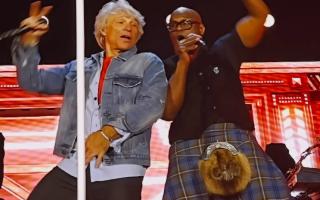 Everett Bradley, pictured alongside Jon Bon Jovi, took to the stage at Murrayfield Stadium in traditional attire